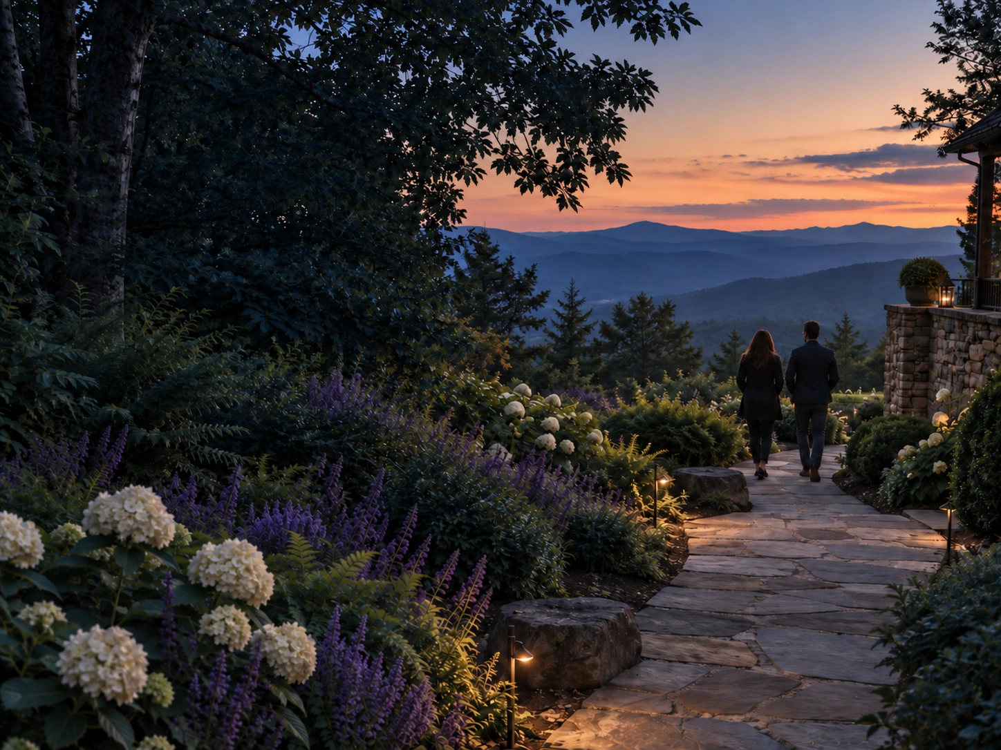 Two household professionals walking through an estate garden toward the Blue Ridge Mountains at sunset